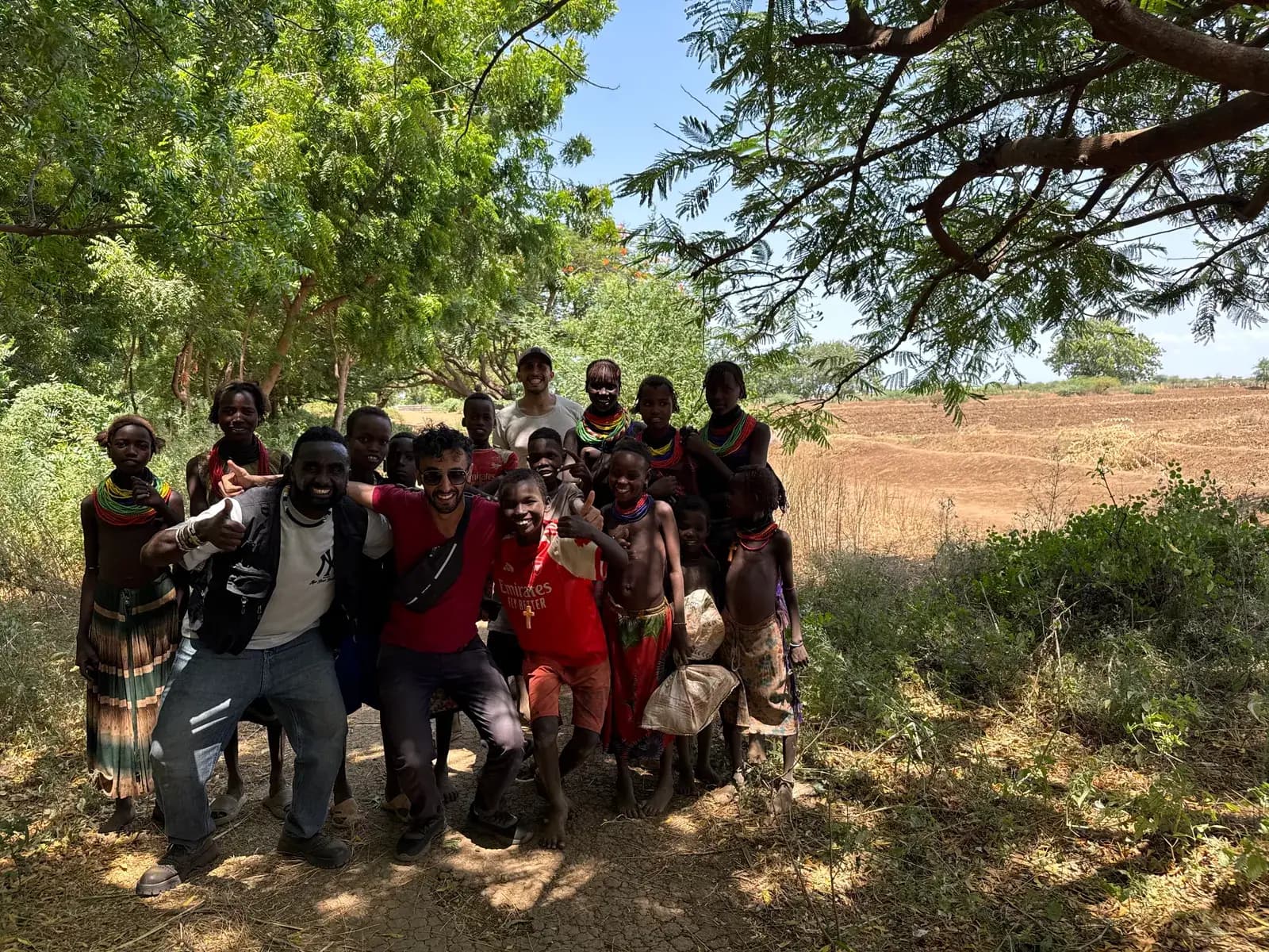 With local men under an acacia tree
