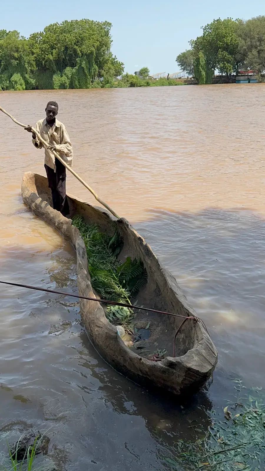 Crossing the Omo River by dugout canoe